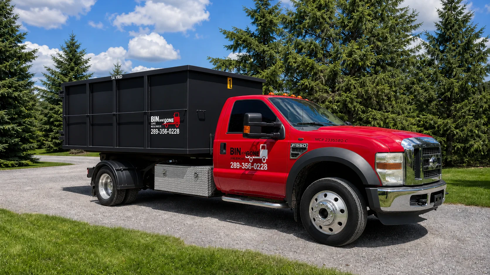 Bin and Gone red truck carrying the black 14-yard bin